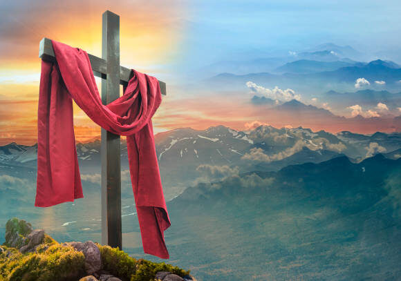 Christian cross against the sky over the mountains